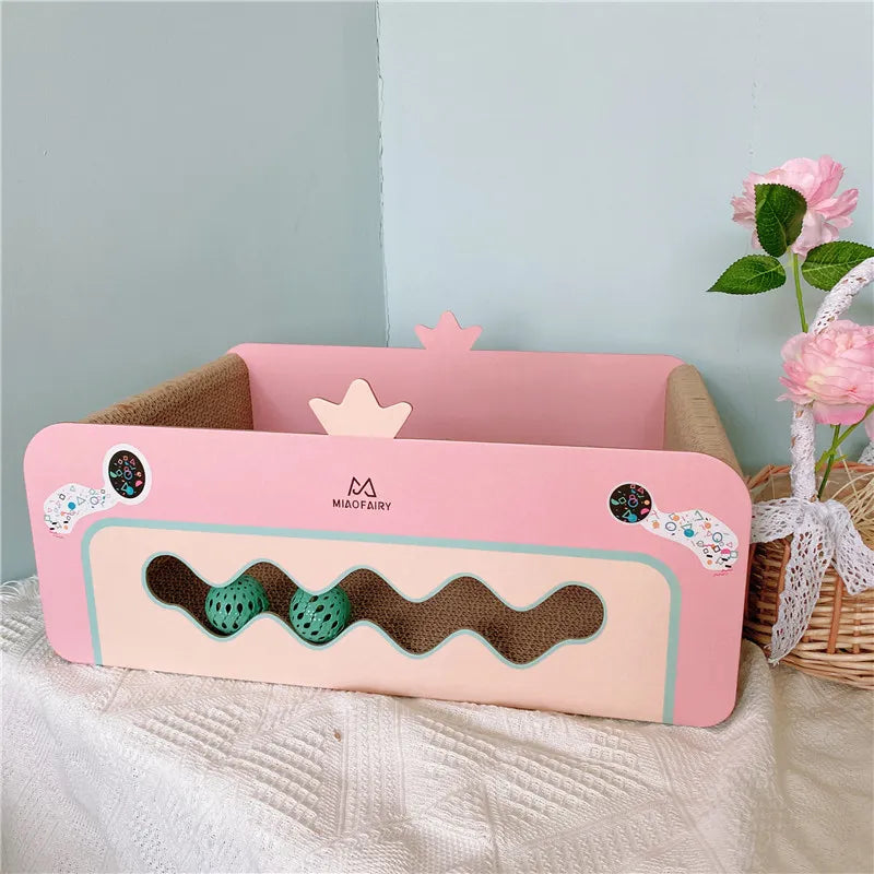 Durable pink cat scratching box with attached toys, perfect for kitten play & furniture protection.