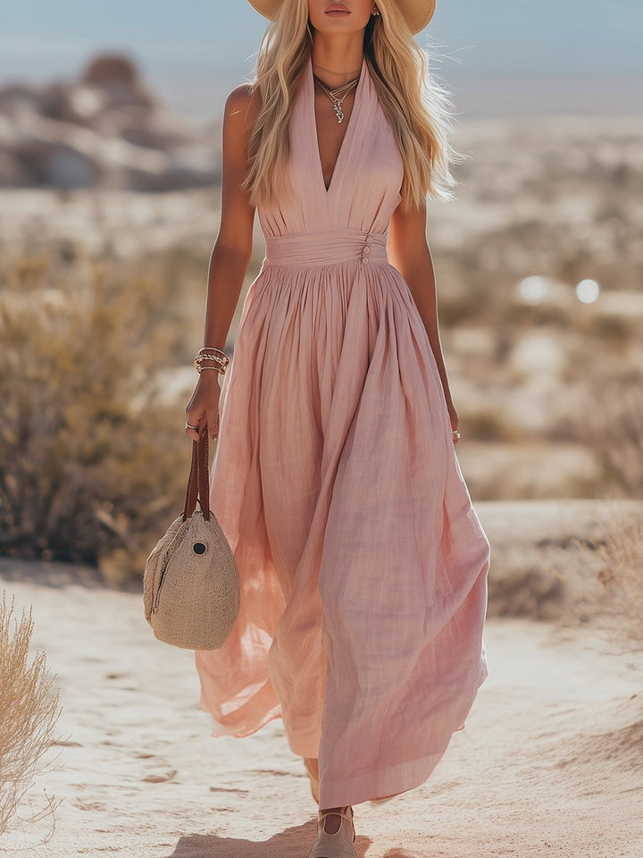 Pink flowing halterneck maxi dress for women. Ideal summer casual wear or vacation outfit.