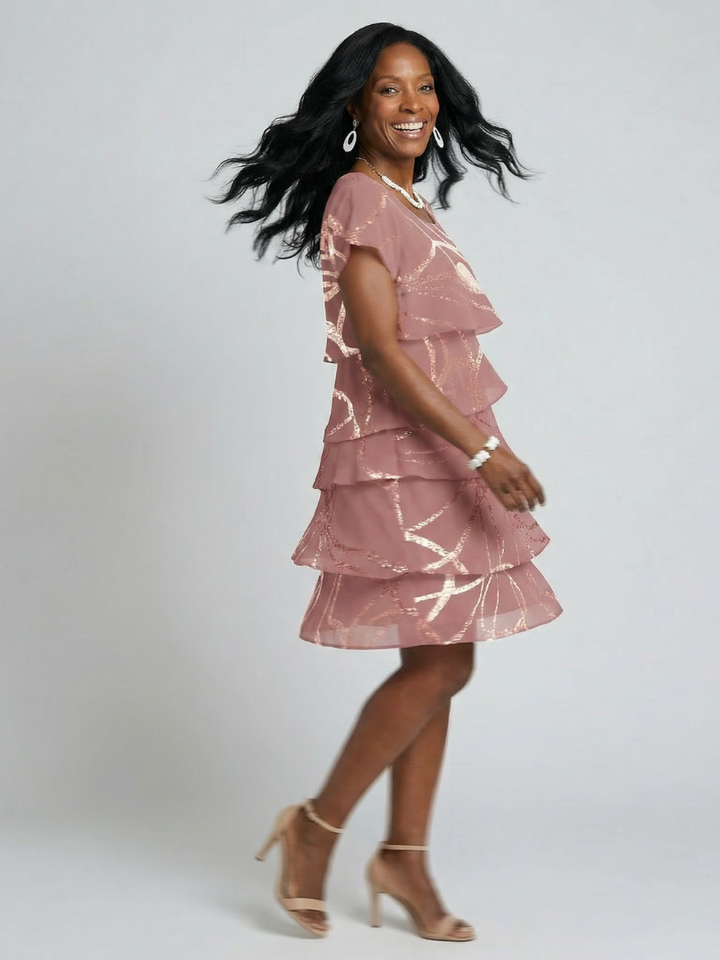 Casual women's abstract print knee-length dress in pink. Comfortable, relaxed fit with short sleeves, perfect for summer.