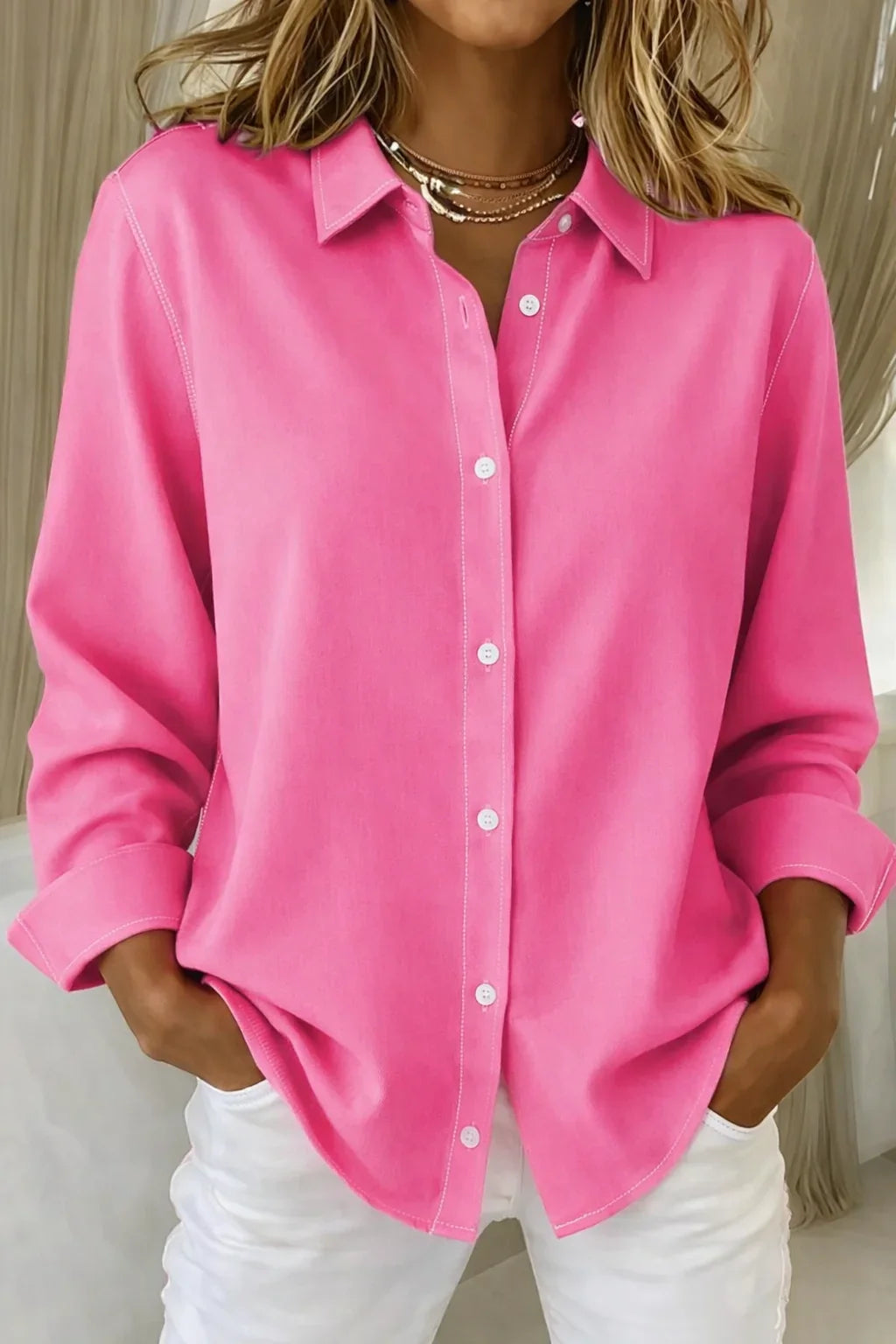 Pink women's long-sleeve collared blouse with button-front closure and stylish contrast stitching. Chic workwear.