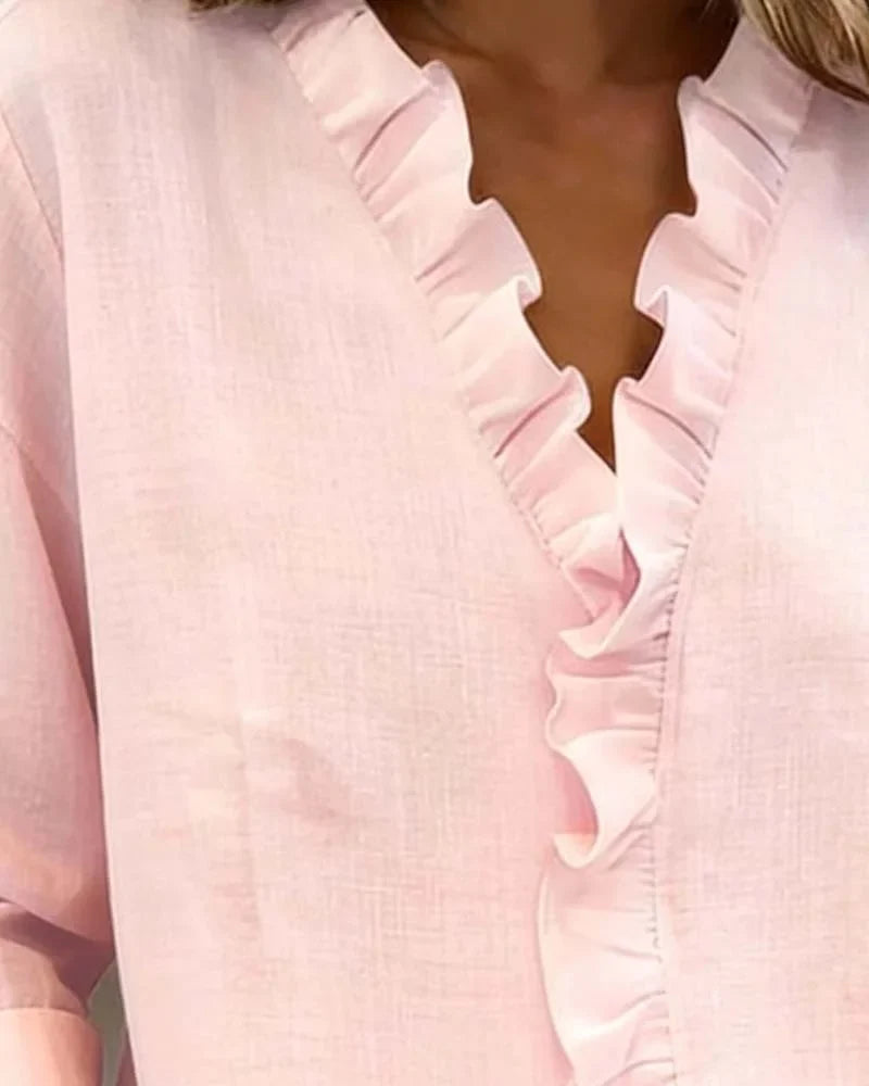 Elegant pink ruffle V-neck blouse with long sleeves. A versatile, relaxed fit top for everyday spring wear.