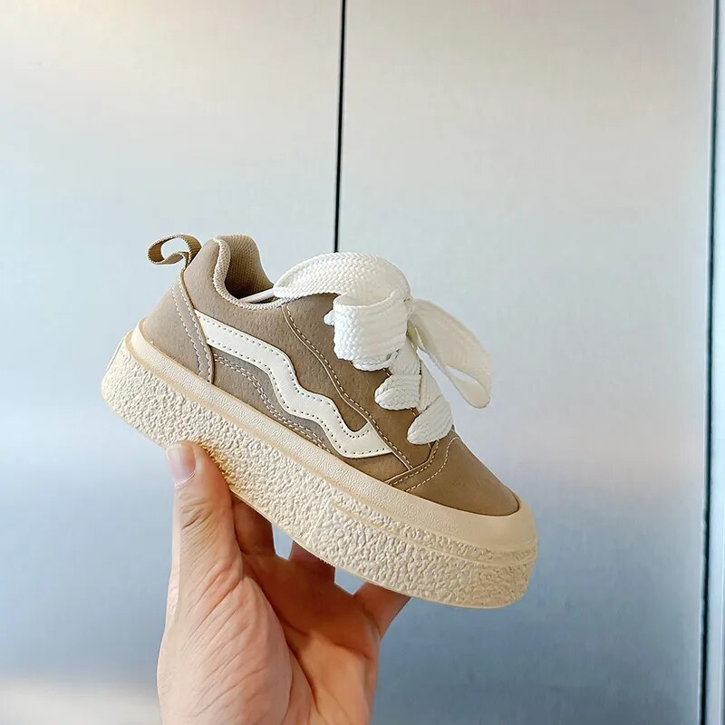 Black playful kids sneakers, comfortable for active boys & girls; durable junior shoes for all adventures.
