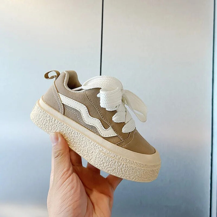 Black playful kids sneakers, comfortable for active boys & girls; durable junior shoes for all adventures.