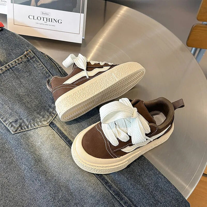 Stylish black kids sneakers, comfy for girls & boys; perfect playful footwear for daily adventures.