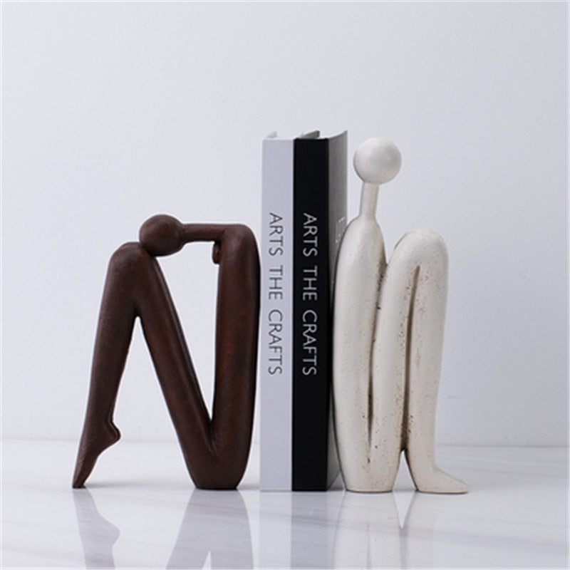 Playful character bookends in white and brown, adding unique design to books and desk decor.
