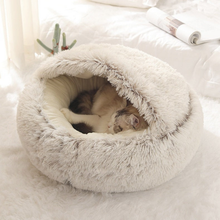 High-quality plush cat cuddle cave pet bed with a comfortable hood. A washable, cozy pet supply for cats.