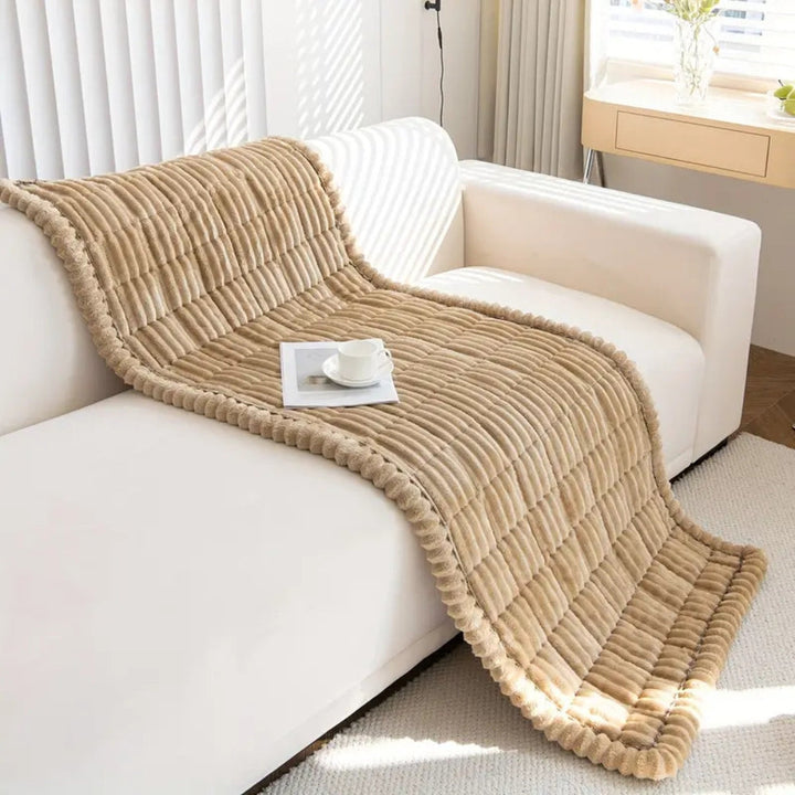 Quilted plush fleece sofa protector mat, non-slip, stylish and pet-friendly furniture cover.