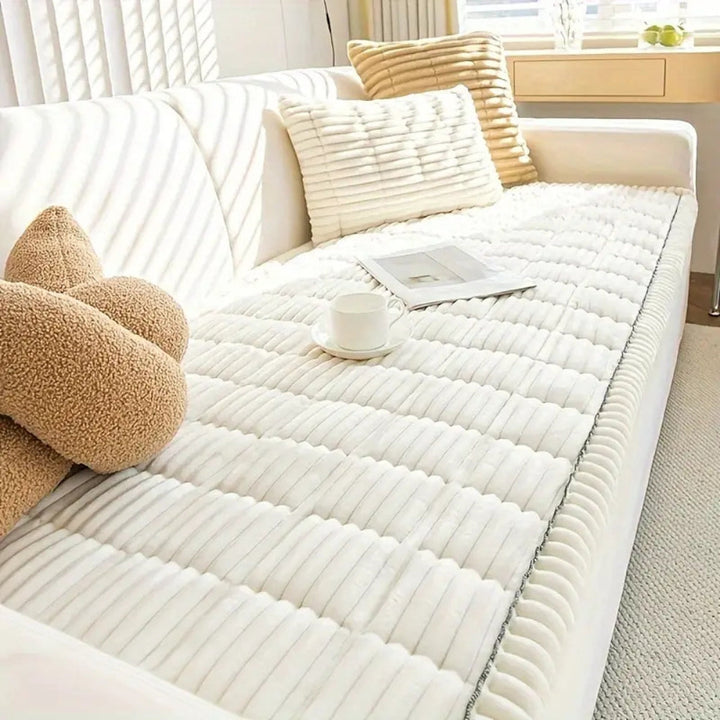 Soft fleece texture plush sofa protector, quilted & pet-friendly, ensures cozy home comfort.