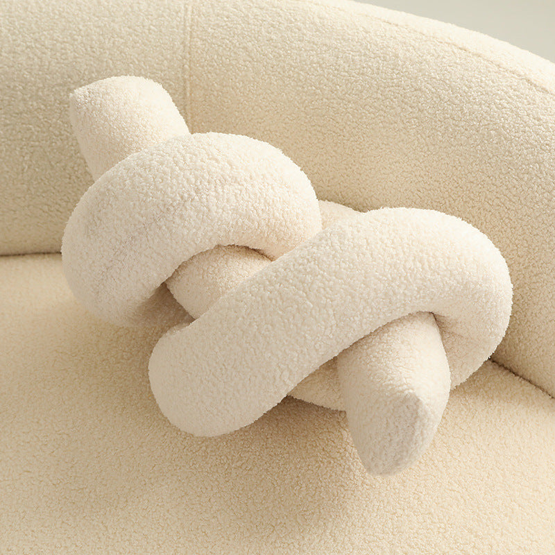 Decorative plush cactus for living rooms, a soft accent pillow providing comfort.