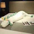 Whimsical green dragon body pillow, a large plush toy for playful kids' rooms or quirky adult decor.