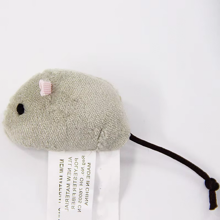 Happy indoor cat playing with a soft plush mouse toy, satisfying its natural pouncing and hunting urges.