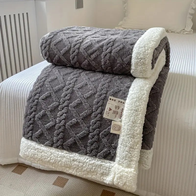 Premium plush Sherpa throw blanket, ultra-soft and reversible, providing luxurious all-season comfort.