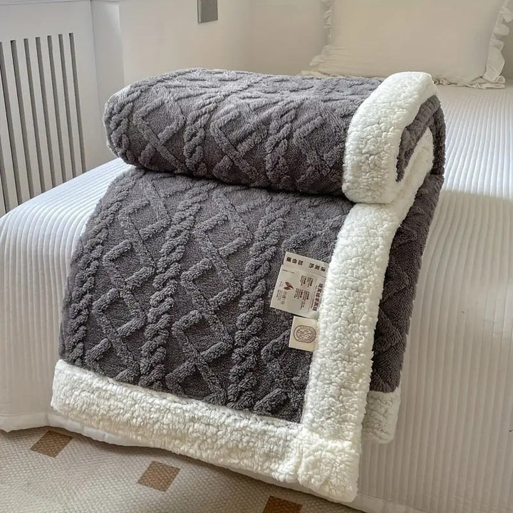 Premium plush Sherpa throw blanket, ultra-soft and reversible, providing luxurious all-season comfort.