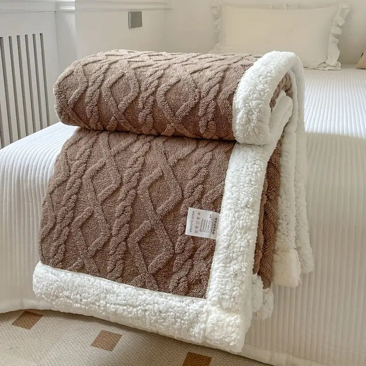 Neatly folded plush Sherpa throw blanket, displaying its soft texture and cozy appeal for home decor.