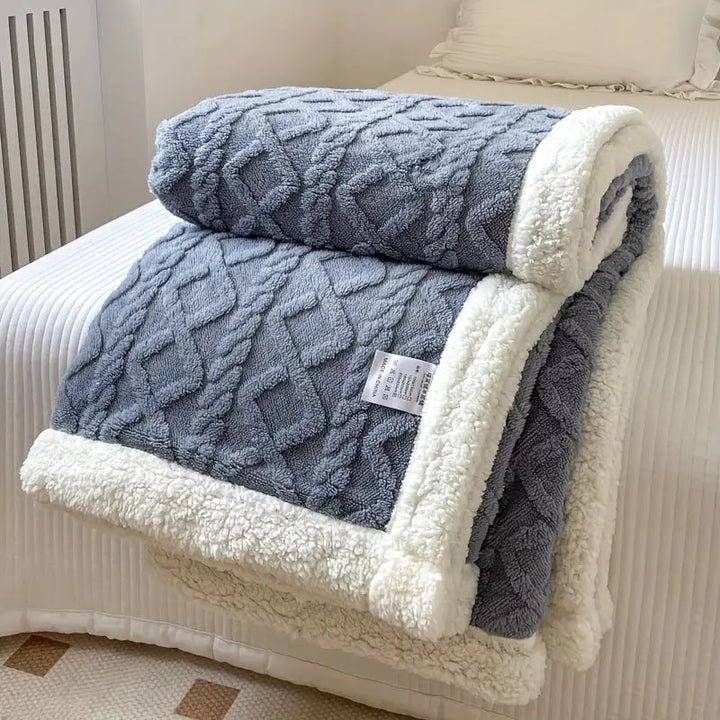 Cozy plush Sherpa throw blanket, soft and inviting, enhances any home decor with ultimate comfort.