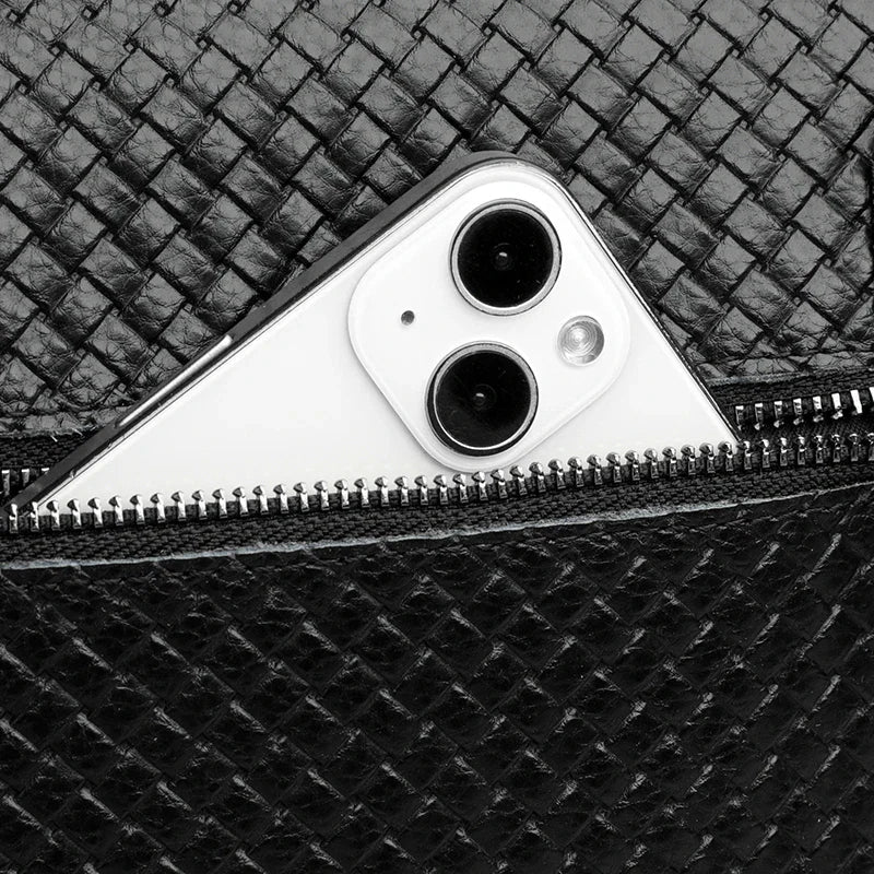Detailed hardware & zippers on men's leather crossbody bag. Built for durability & style.