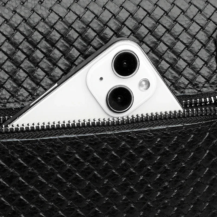 Detailed hardware & zippers on men's leather crossbody bag. Built for durability & style.