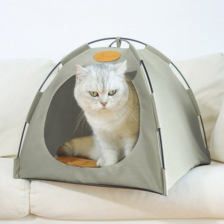 Stylish pet accessories: a beige rattan cat tent that doubles as a chic piece of furniture.