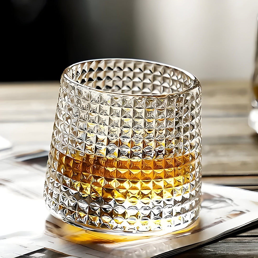 Elegant rotating crystal tasting glass, textured design for premium whiskey & cocktails. Enhance your drinkware collection.