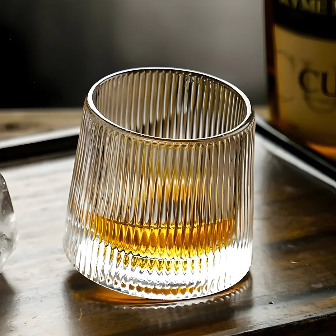 Unique textured crystal rotating whiskey glass. A premium tasting glass for spirits, adding modern elegance to any home bar.