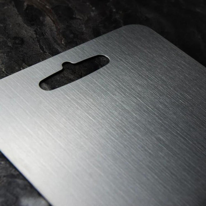 Durable silver stainless steel cutting board, ideal for hygienic food prep. Non-slip kitchen essential.