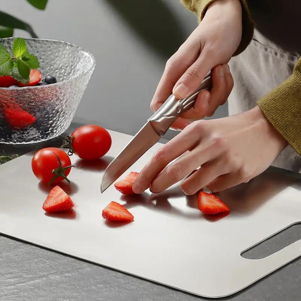 New silver stainless steel cutting board, ensuring kitchen hygiene for all food prep. Durable kitchenware.