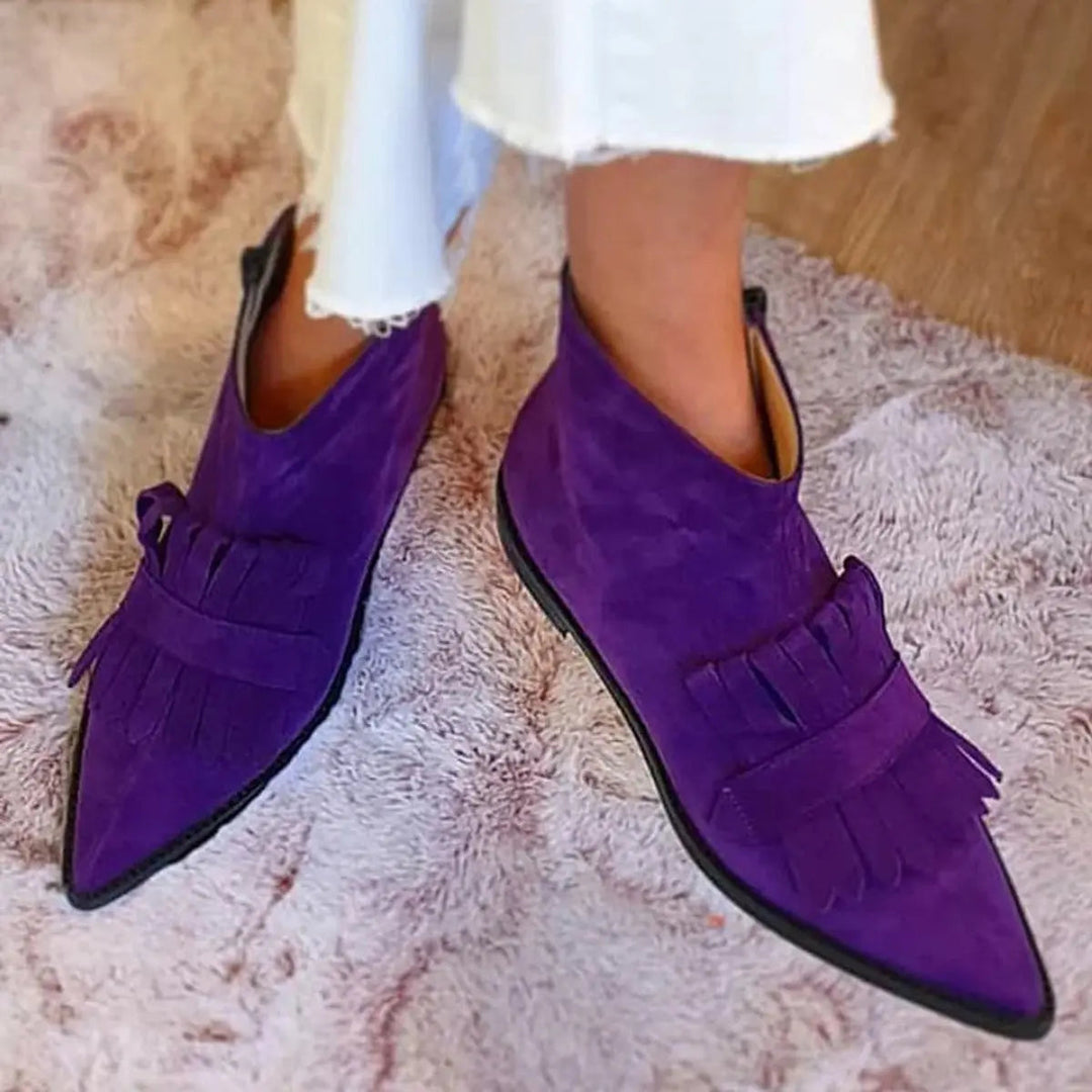 Comfortable purple flat ankle boots for women, featuring chic fringe detail & a sleek pointed toe, perfect for everyday style.