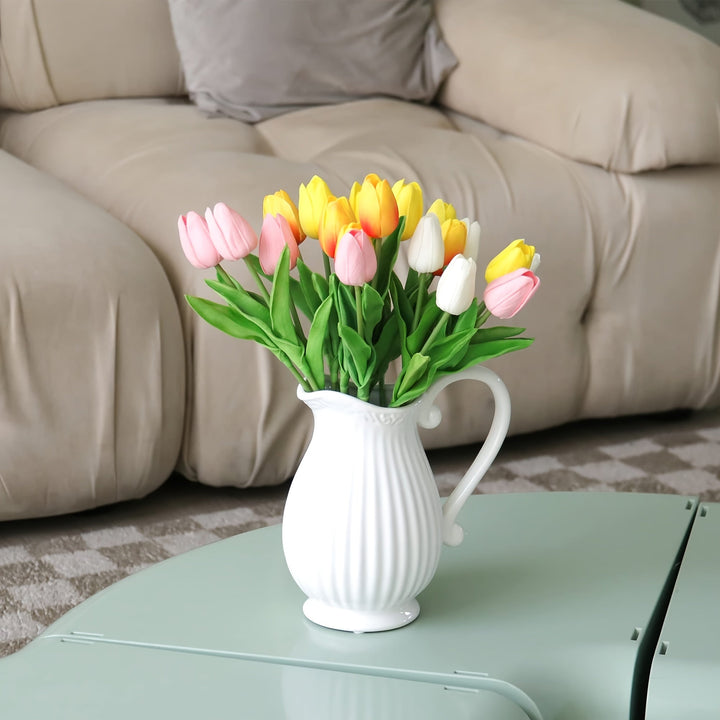 Group of realistic artificial tulips (orange, white, pink). Decorative faux floral for spring home & wedding decor.