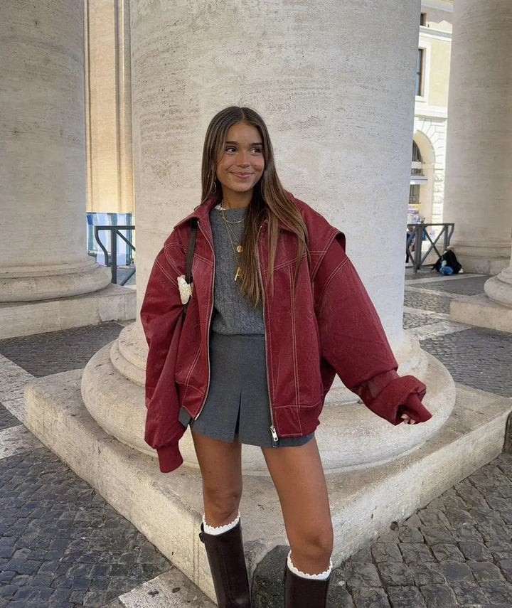 Red oversized quilted bomber jacket for women with contrast stitch, casual autumn fashion.
