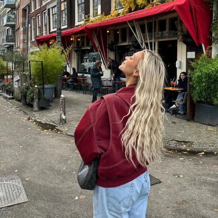 Modern red oversized quilted bomber jacket for women, featuring a contemporary contrast stitch.