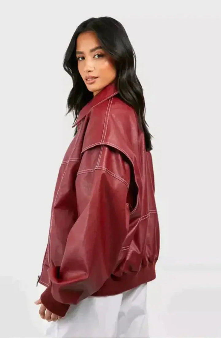 Women's red bomber jacket, oversized and quilted with distinct contrast stitch detailing.