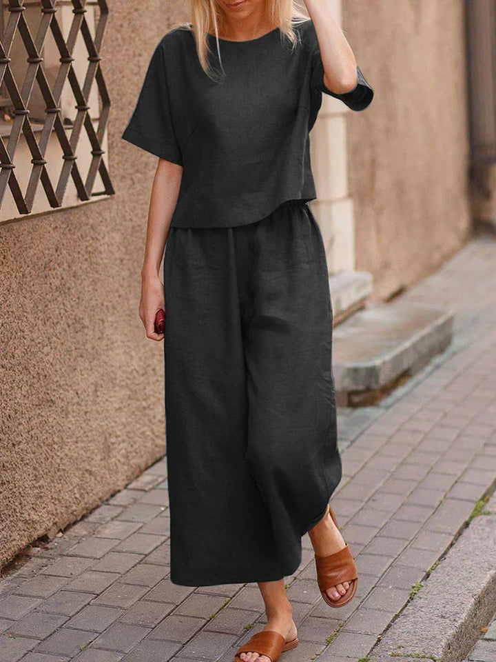 Stylish women's linen two-piece outfit featuring a relaxed top and wide-leg pants for casual summer wear.