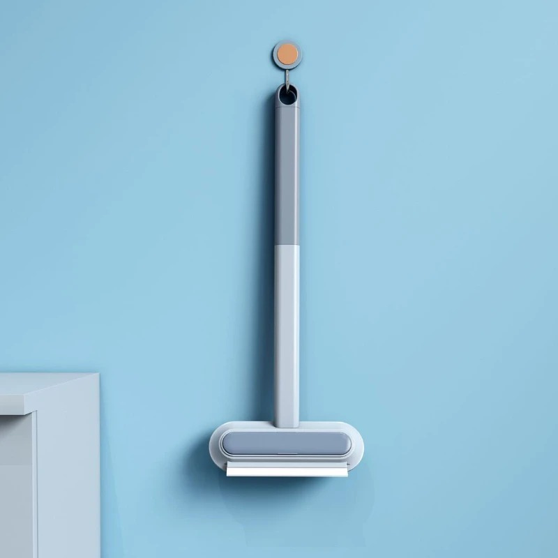 Reusable pet hair and lint remover tool with a squeegee edge for effective fabric cleaning.
