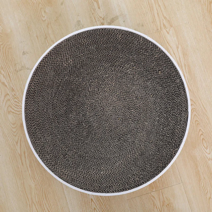 Cat's round scratching mat provides fun, relaxation, and healthy claw maintenance. Essential pet care item.