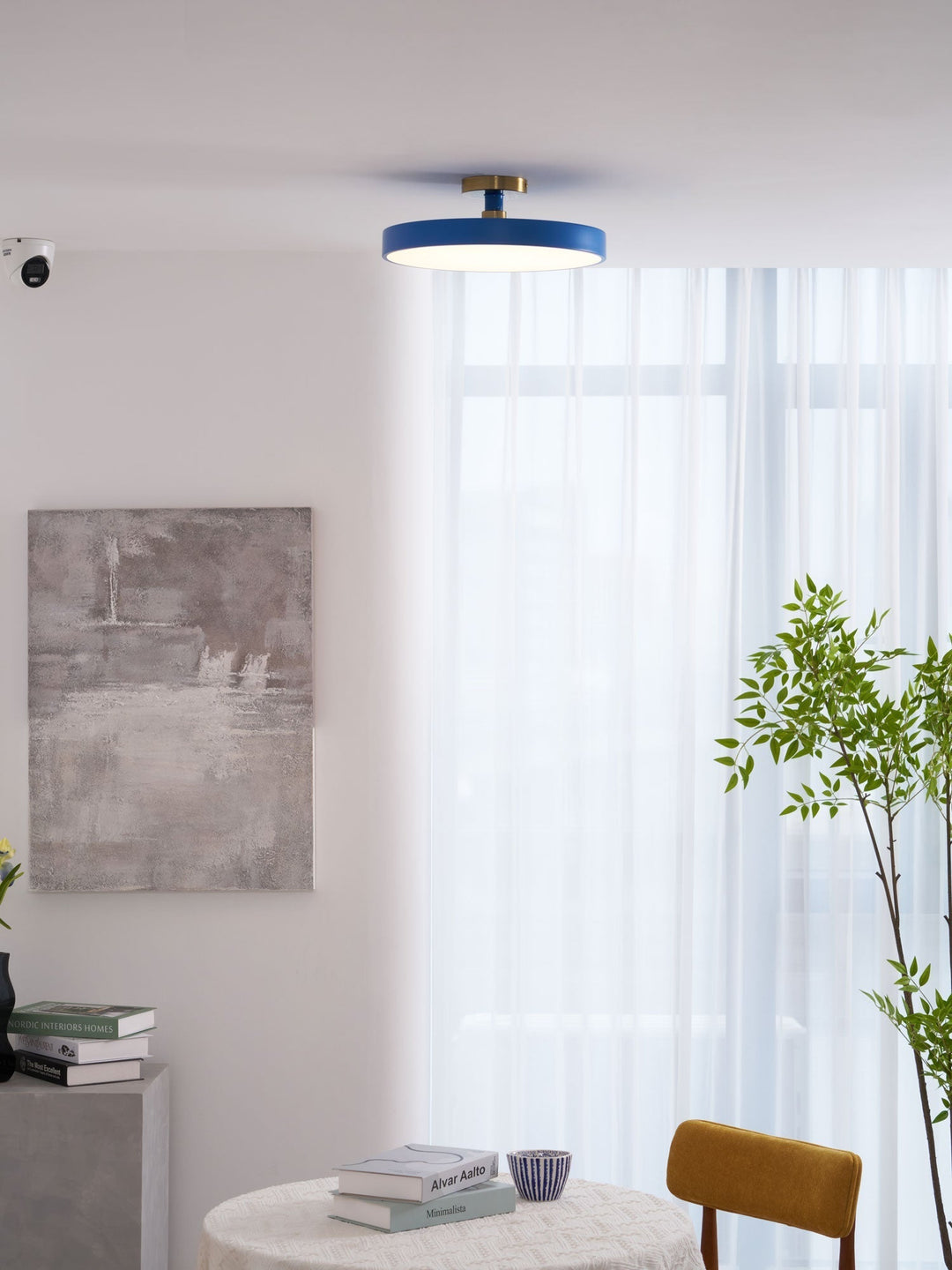 Contemporary round LED flush mount, provides warm, dimmable light for homes.