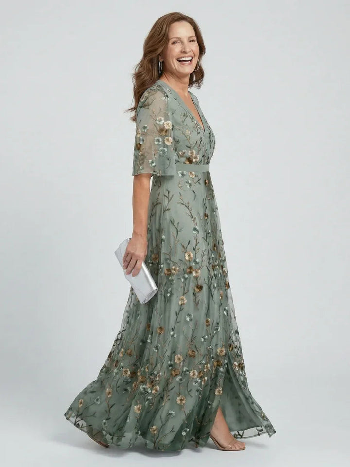 Women's sage green floral embroidered maxi dress with drop waist and flutter sleeves, ideal for summer wedding guests.