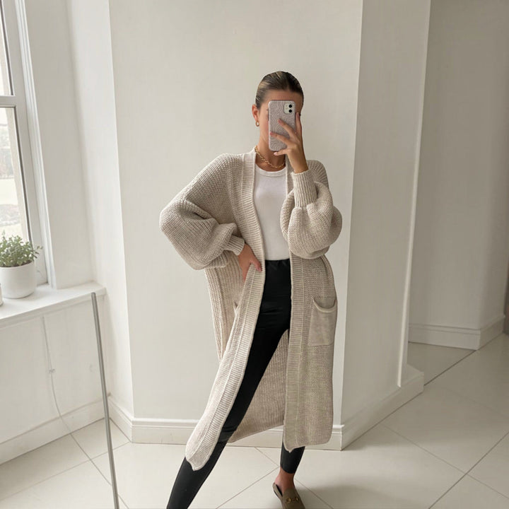 Soft knit longline women's cardigan, sand color, bell sleeves, perfect for versatile everyday layering.