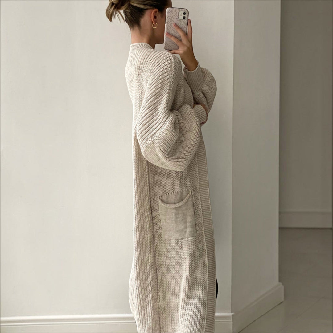 Women's elegant longline cardigan in sand, soft knit, bell sleeves, a comfortable everyday layering piece.
