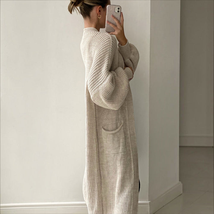 Women's elegant longline cardigan in sand, soft knit, bell sleeves, a comfortable everyday layering piece.