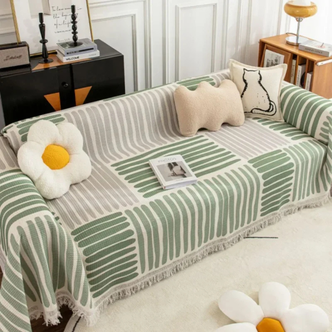 Soft decorative throw blanket for sofas. Features a stylish pattern & tassels, enhancing any home decor.