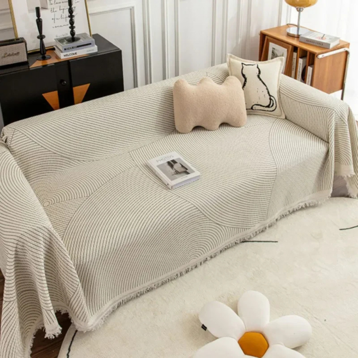 Unisex Scandinavian modern throw blanket. Cozy patterned sofa accessory with tassels for chic home decoration.