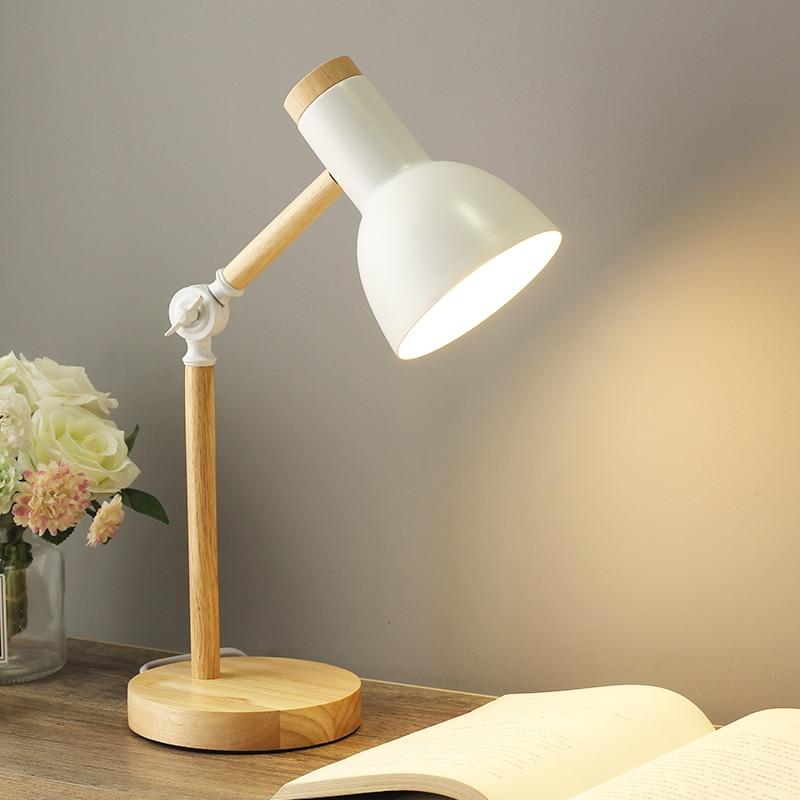 Scandinavian wooden table lamp, foldable & adjustable, adds warm lighting to a modern bedroom.