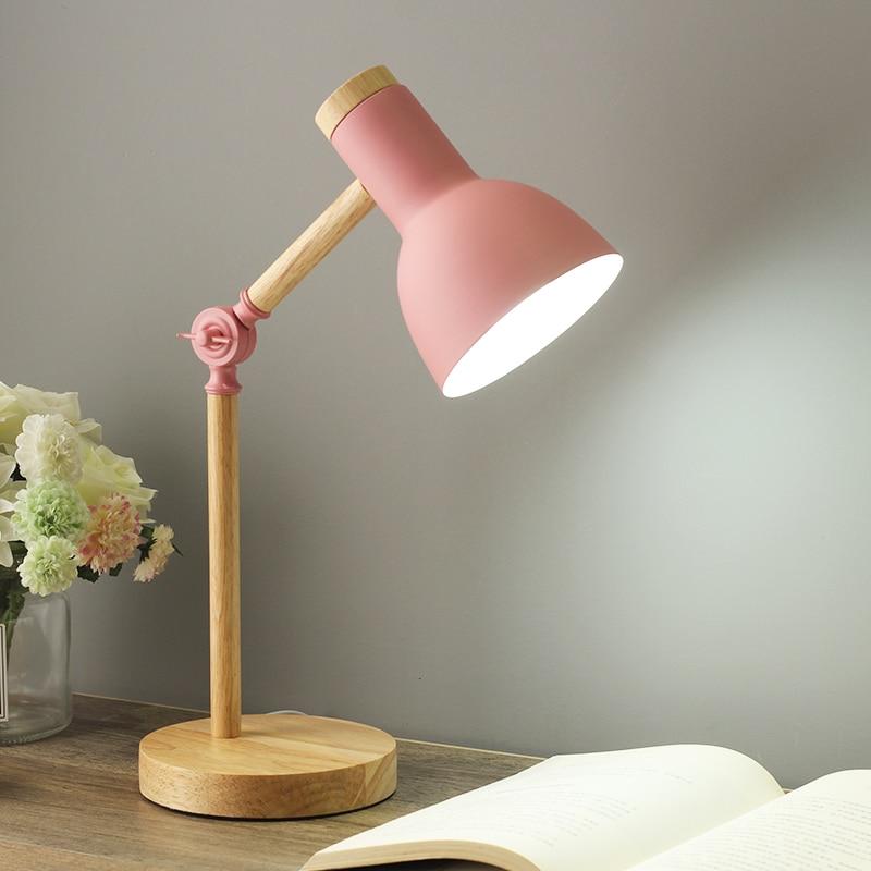 Adjustable wooden desk lamp, foldable & space-saving, a minimalist Scandinavian lighting solution.
