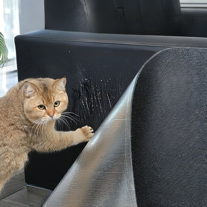 ScratchScape stick-on cat scratching mat protecting a sofa corner