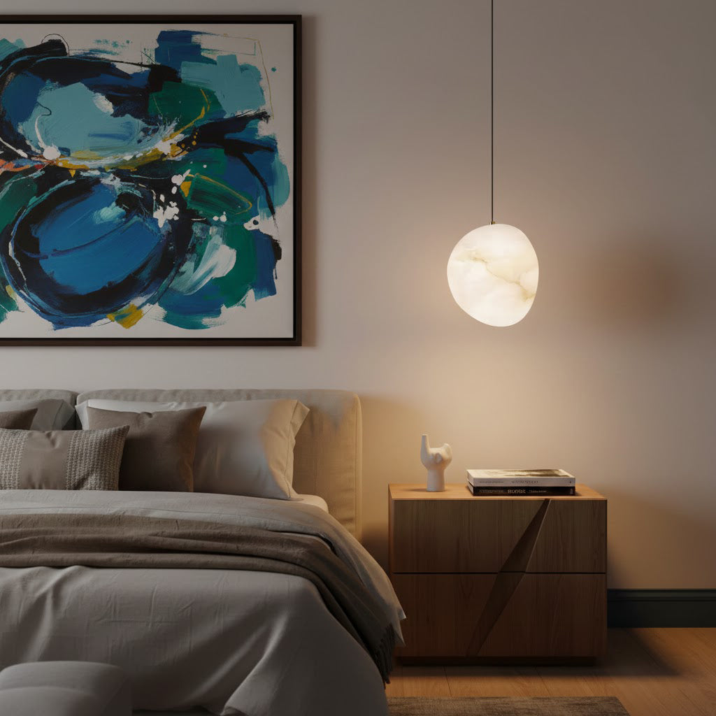 Modern brass pendant light, sculptural pebble design, perfect for Japandi style living rooms.