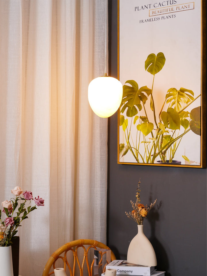 Chic ceiling lamp: brass finish sculptural pebble pendant for a serene and stylish home.