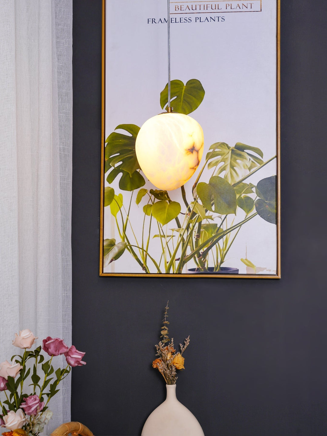 Brass pebble pendant light, a unique sculptural piece providing ambient modern lighting.