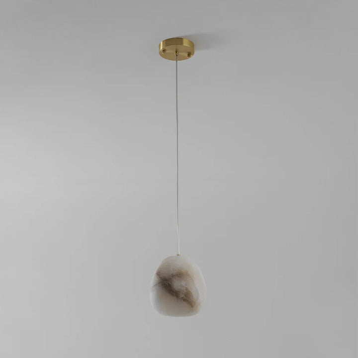 Modern home decor: brass sculptural pebble pendant light, elegant and serene.