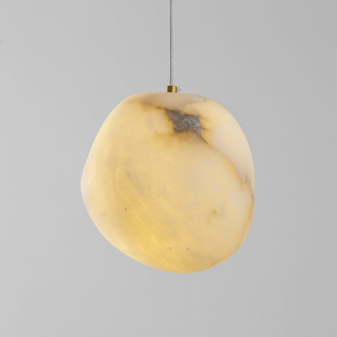 Sculptural pebble pendant light, brass finish, a modern classic for ambient home lighting.