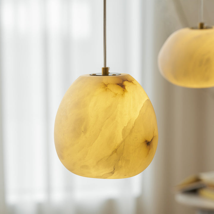 Japandi style decorative lighting, brass sculptural pebble pendant, modern ceiling fixture.